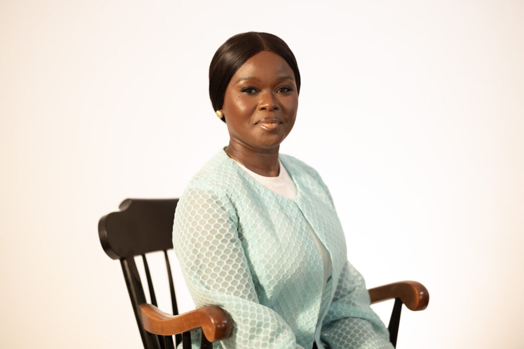 Woman seating on chair against white background